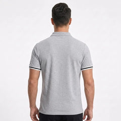 MannerCo light gray polo shirt back view with black and white striped sleeve cuffs