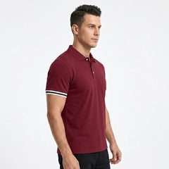 MannerCo wine red polo shirt with striped sleeve cuffs, side view on male model