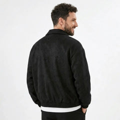 Man wearing MannerCo black PU leather retro lapel jacket in outdoor lifestyle setting
