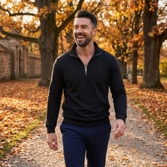 Man wearing MannerCo black quarter zip mock neck sweater in outdoor lifestyle setting
