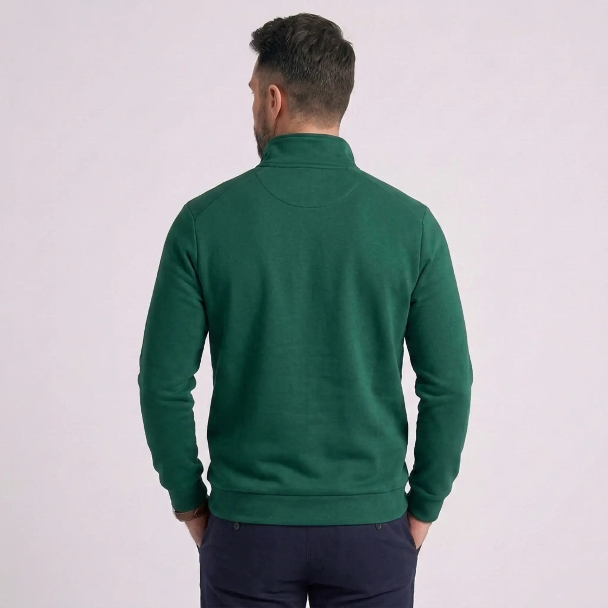 Man wearing MannerCo green quarter zip mock neck sweater slim fit, back view on plain background