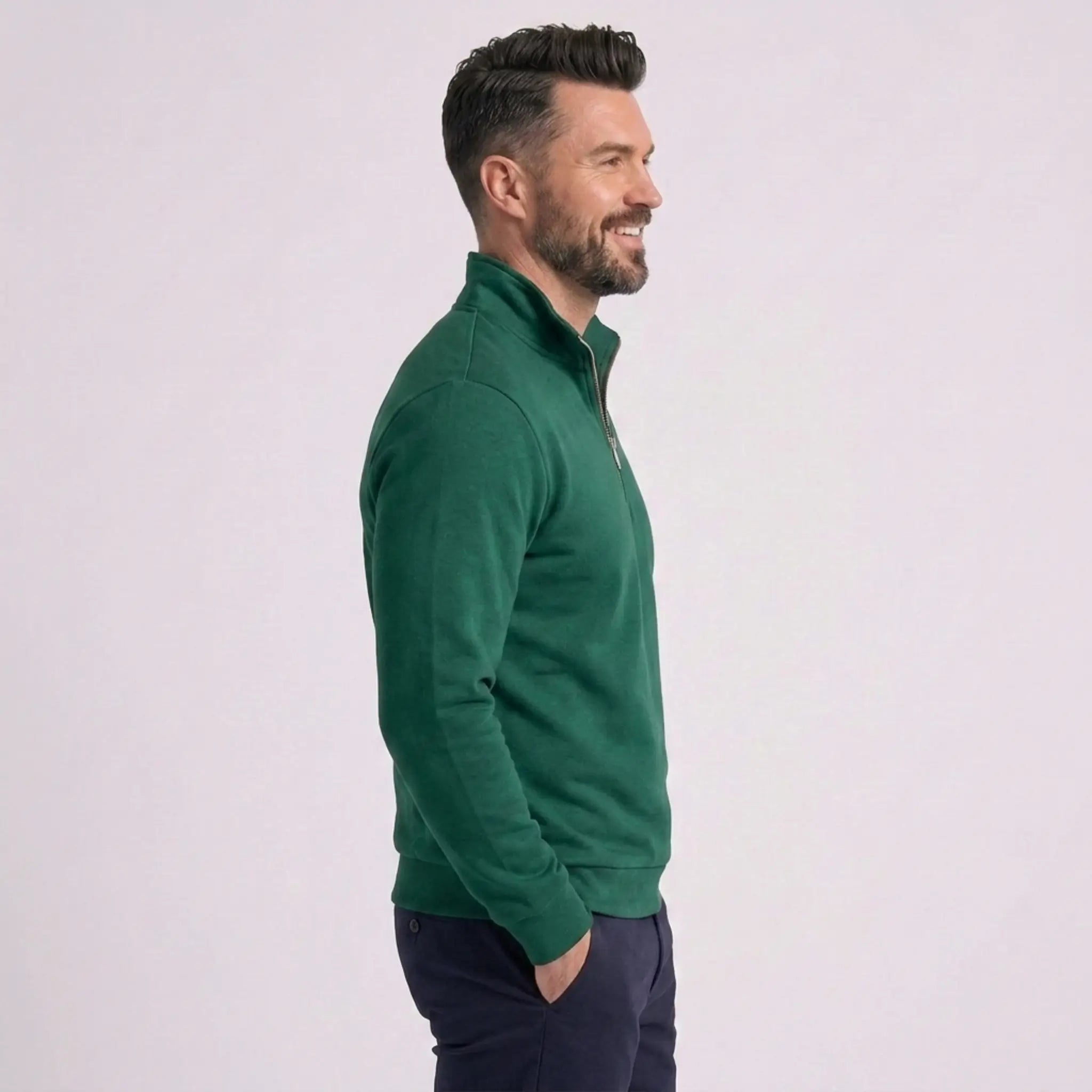 Man wearing MannerCo green quarter zip mock neck sweater slim fit, side view on plain background