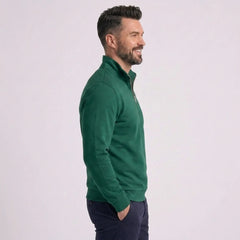 Man wearing MannerCo green quarter zip mock neck sweater slim fit, side view on plain background