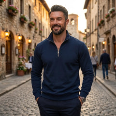 Man wearing MannerCo navy blue quarter zip mock neck sweater in outdoor lifestyle setting