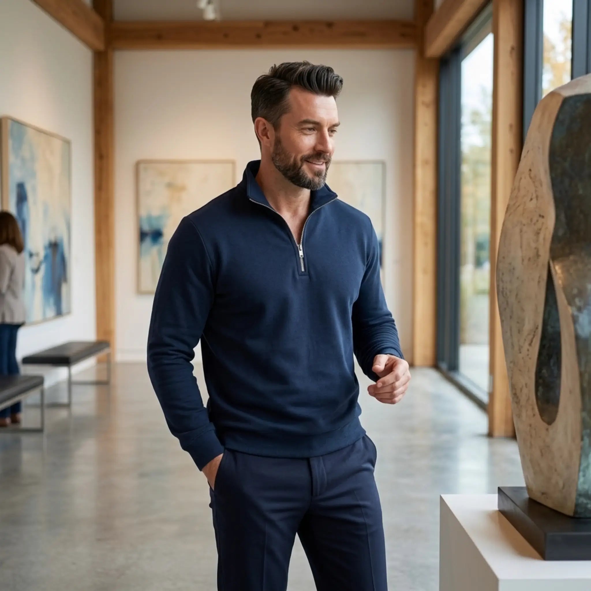 Man wearing MannerCo navy blue quarter zip mock neck sweater in outdoor lifestyle setting