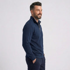 Man wearing MannerCo navy blue quarter zip mock neck sweater slim fit, side view on plain background