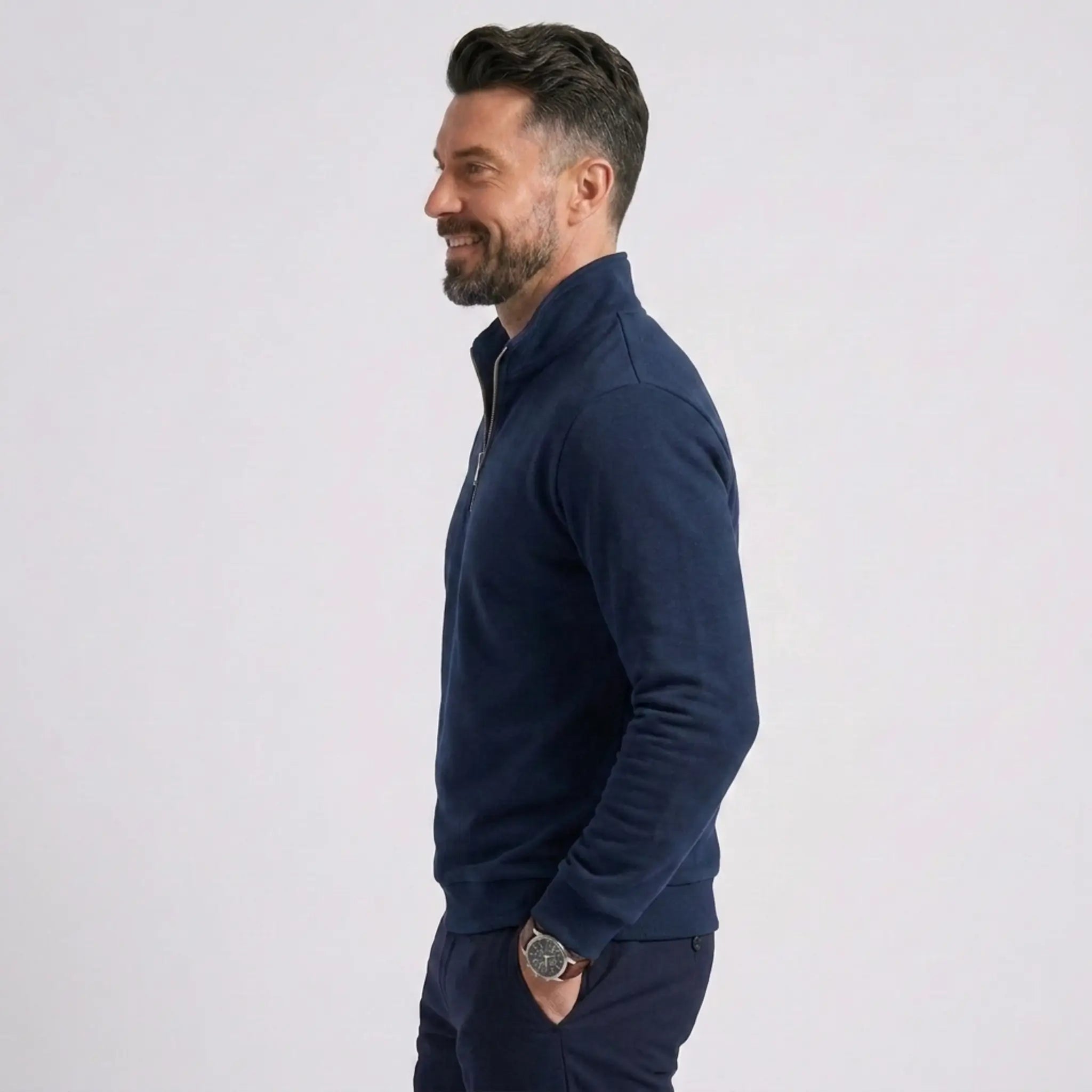 Man wearing MannerCo navy blue quarter zip mock neck sweater slim fit, side view on plain background