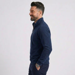 Man wearing MannerCo navy blue quarter zip mock neck sweater slim fit, side view on plain background