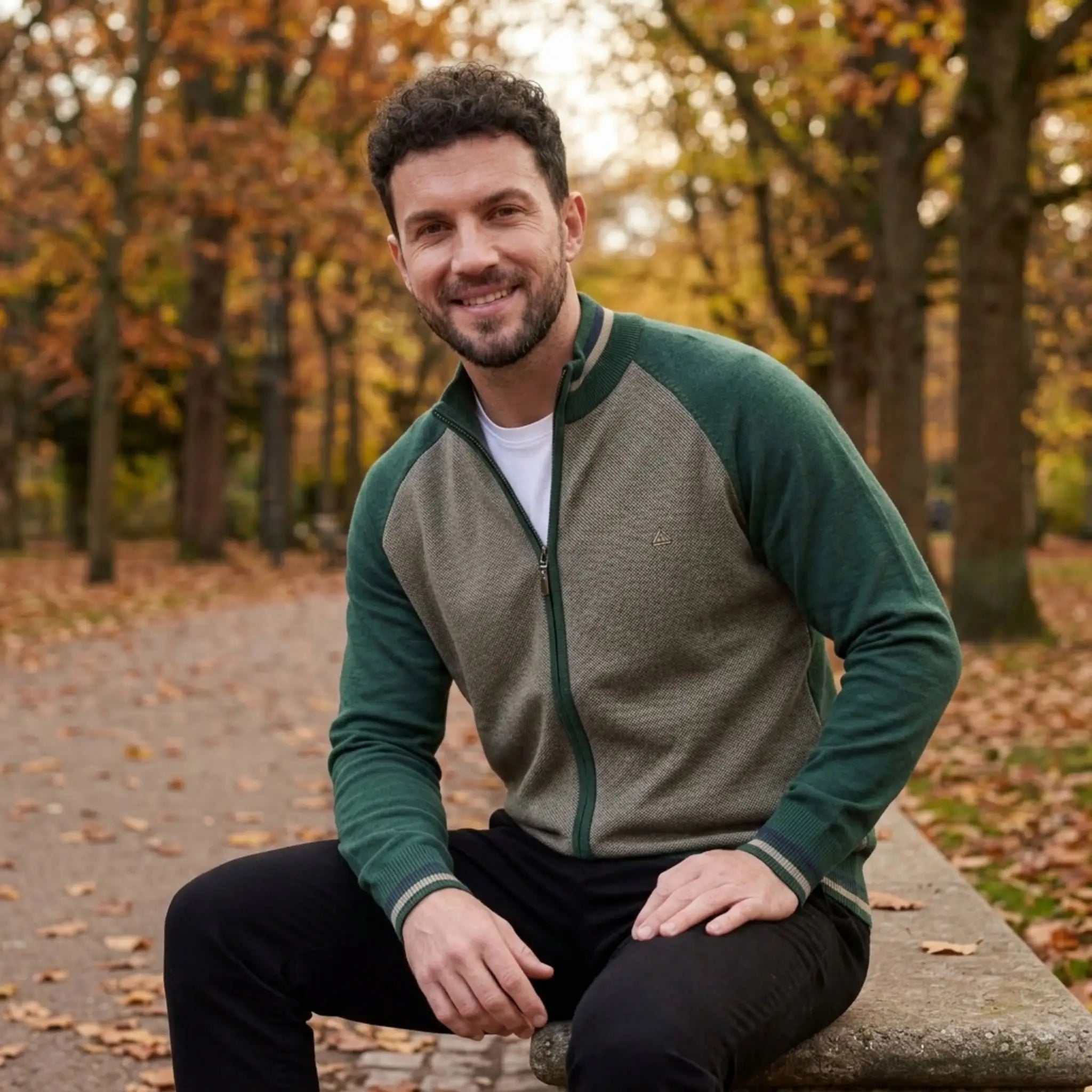 MannerCo green raglan sleeve cardigan sweater with stand-up collar worn outdoors in autumn park