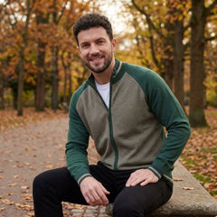 MannerCo green raglan sleeve cardigan sweater with stand-up collar worn outdoors in autumn park