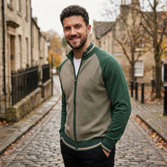 MannerCo green raglan sleeve cardigan with stand-up collar slim fit worn outdoors on cobblestone street