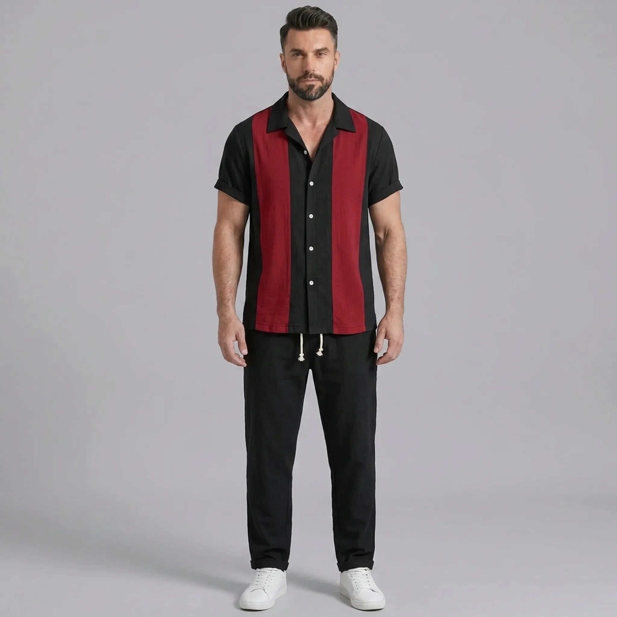 Man wearing a red patchwork cotton bowling shirt and straight leg linen pants front view on plain background
