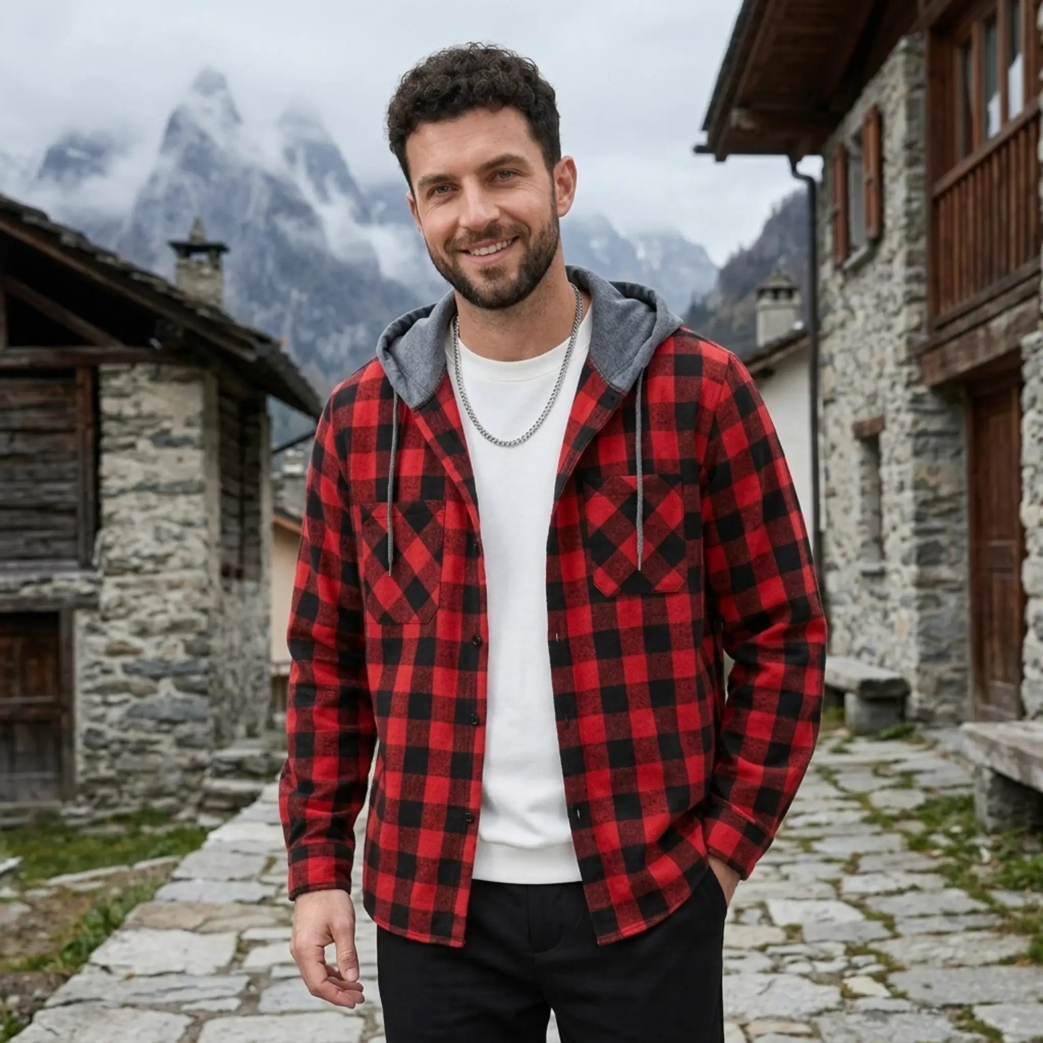 MannerCo red plaid hooded flannel jacket worn by man in alpine village setting