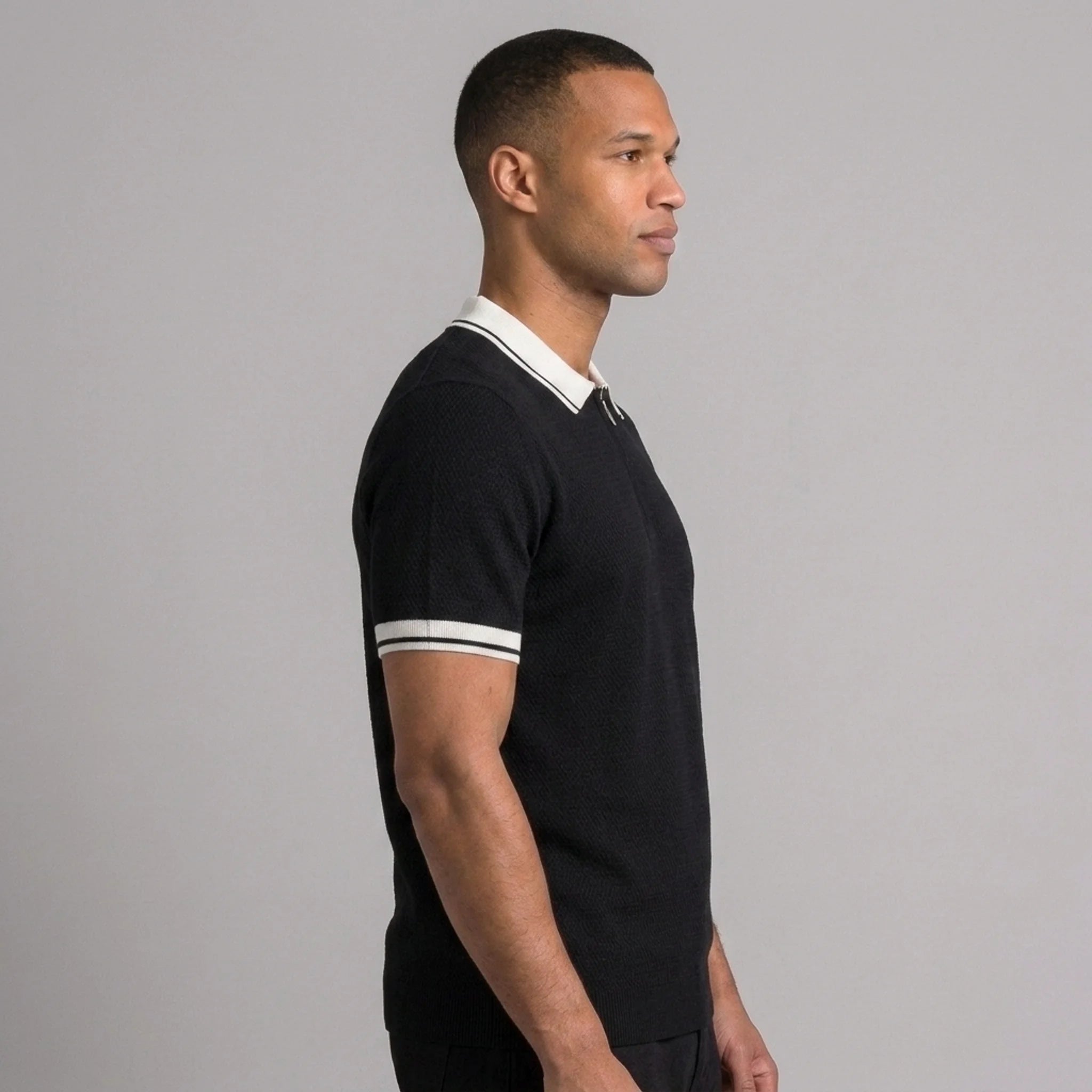 Back view of man wearing royal blue color block knit polo shirt with lapel collar