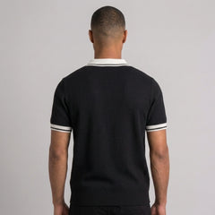 Man wearing royal blue color block knit polo shirt in outdoor lifestyle setting