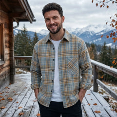 MannerCo sky blue plaid flannel shirt worn outdoors by man at mountain cabin in winter