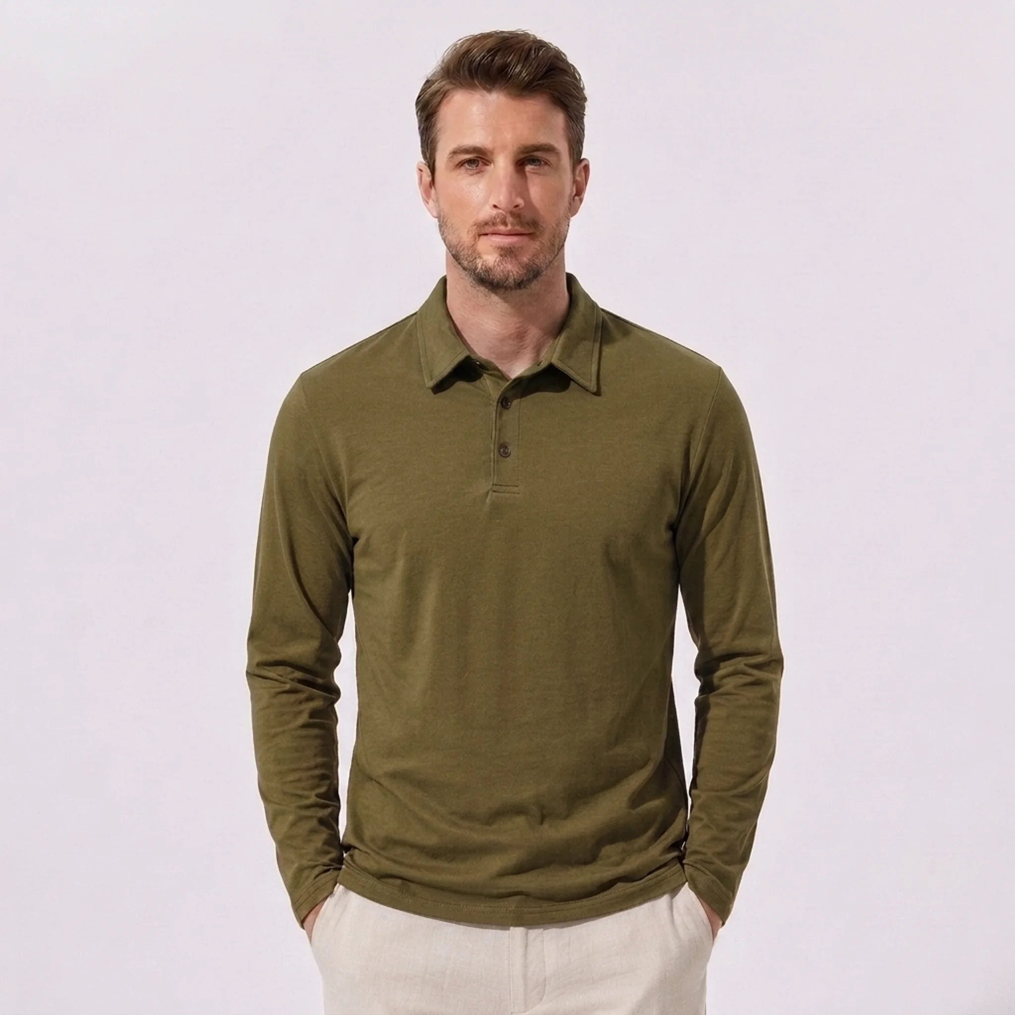 Man wearing sky blue solid long sleeve cotton polo shirt in outdoor lifestyle setting