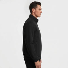 Man wearing MannerCo black stand collar zip-up cardigan jacket in outdoor lifestyle setting