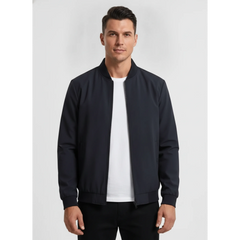 Man wearing MannerCo navy blue stand collar zip-up cardigan jacket, front view on plain background