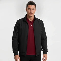 Man wearing MannerCo navy blue stand collar zip-up cardigan jacket in outdoor lifestyle setting