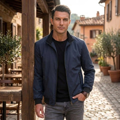 Man wearing MannerCo navy blue stand collar zip-up cardigan jacket in outdoor lifestyle setting