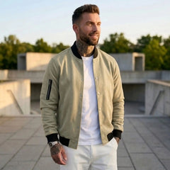 Man wearing MannerCo army green suede-blend stand collar jacket in outdoor lifestyle setting