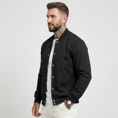 Man wearing MannerCo black suede-blend stand collar jacket, side view on plain background