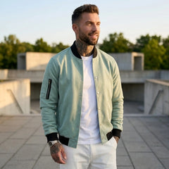 Man wearing MannerCo light green suede-blend stand collar jacket in outdoor lifestyle setting