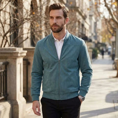Man wearing MannerCo peacock blue suede thermal jacket with zip closure on city street