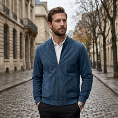 Man wearing MannerCo peacock blue suede thermal jacket on cobblestone street