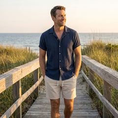 Man wearing tan geometric jacquard shirt and crinkle shorts in outdoor lifestyle setting