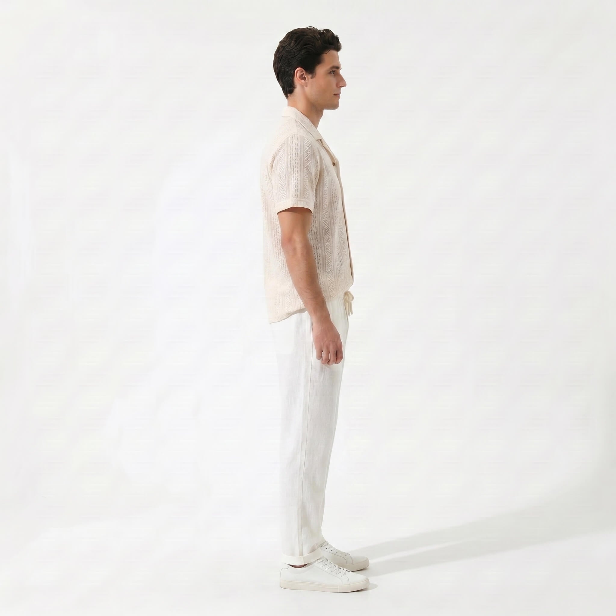 Man wearing tan geometric jacquard button up shirt and straight leg linen pants front view