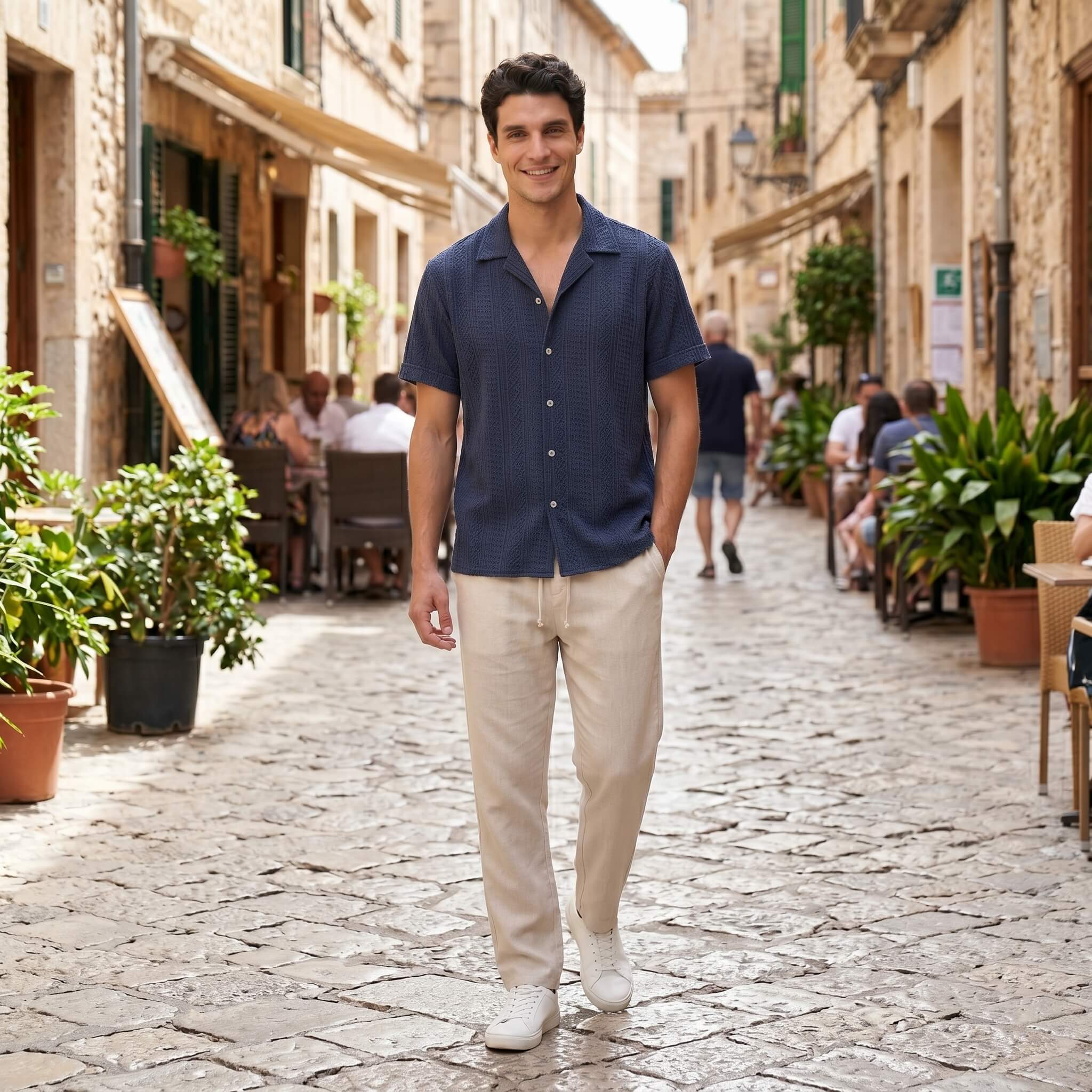 Man in tan geometric jacquard shirt and linen pants in outdoor lifestyle setting