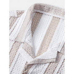 Three quarter view of man wearing tan mesh Cuban shirt and beige straight leg linen pants