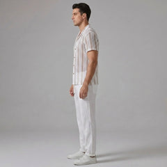 Front view of man in tan open-weave striped mesh shirt and straight leg linen pants on white background