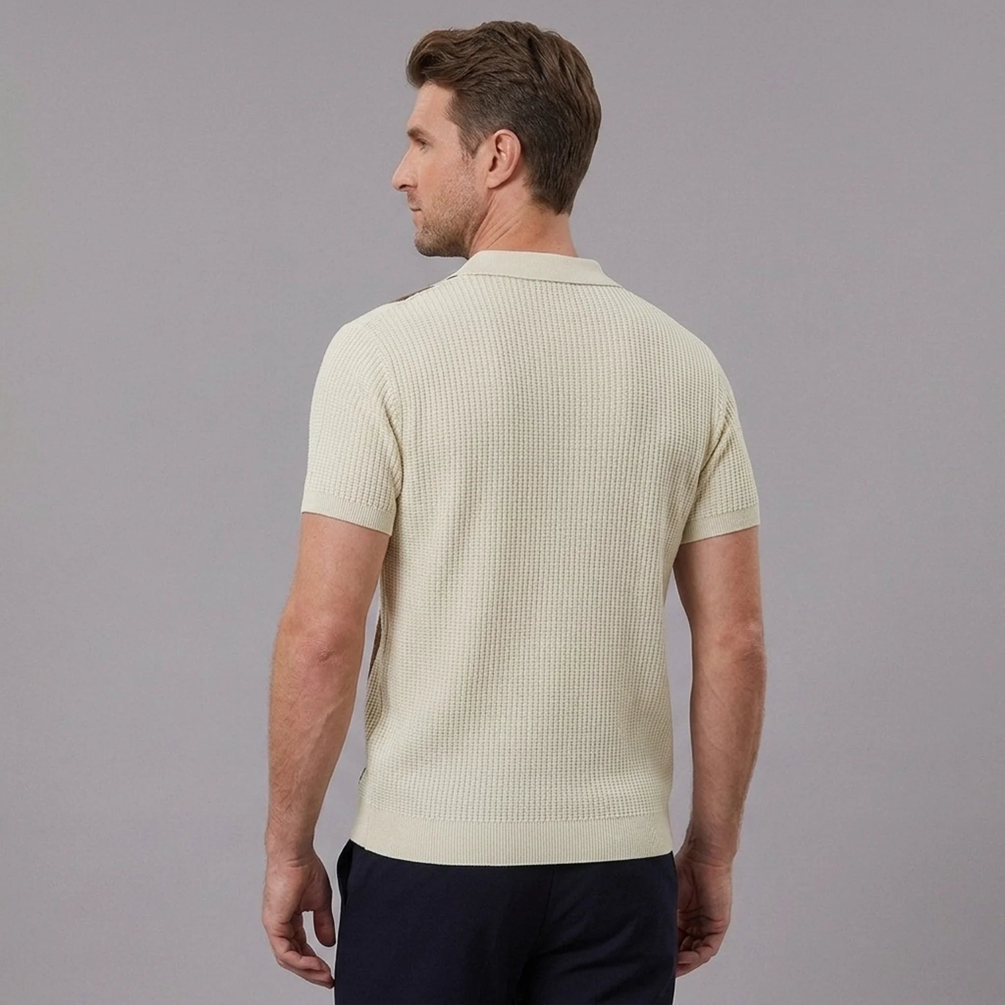 Back view of man wearing tan striped knit slim fit polo shirt