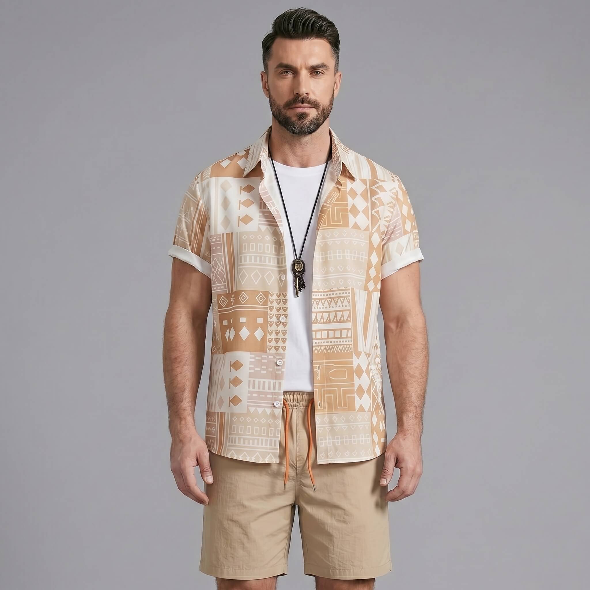 Man wearing a tan tribal geometric patchwork button up shirt and swim shorts front view on plain background