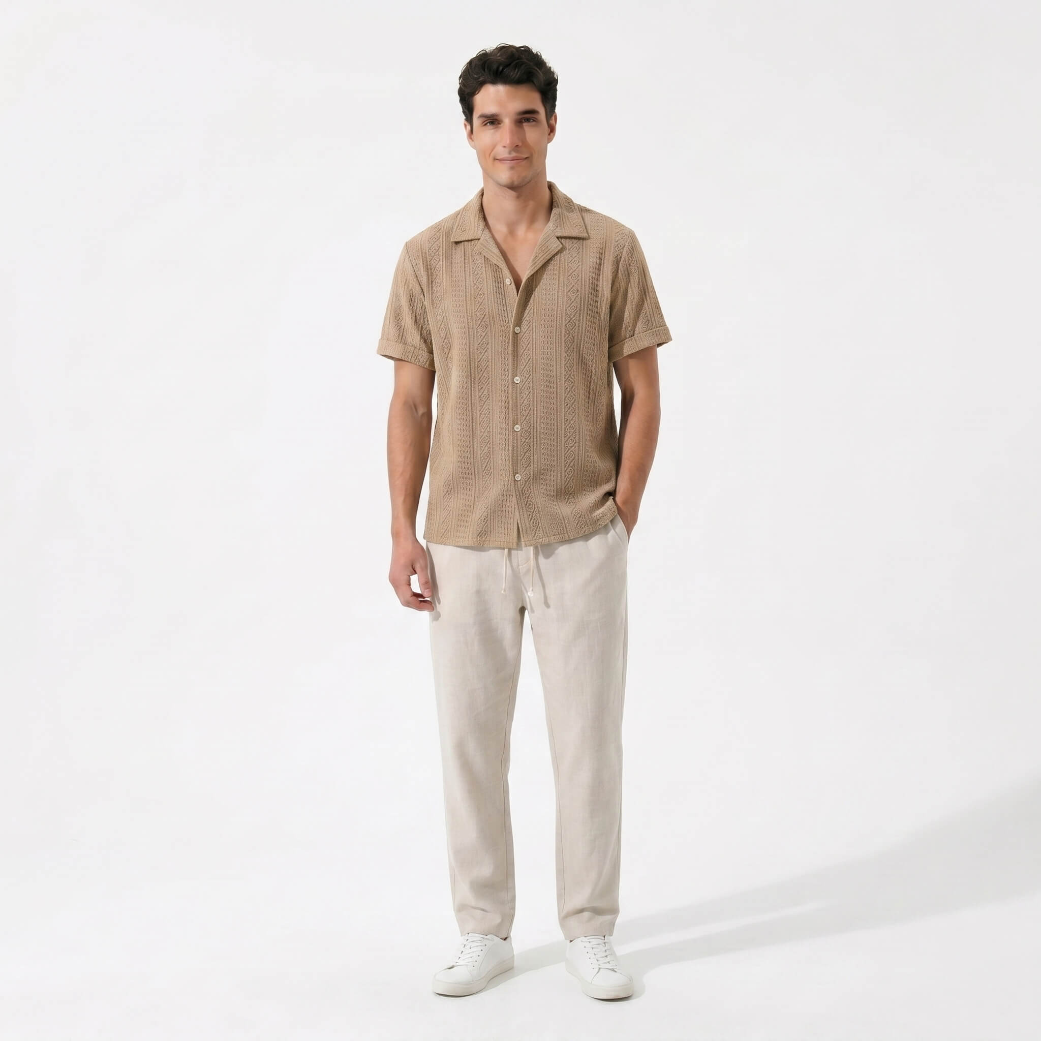 Man in tan geometric jacquard shirt and linen pants walking in sunny outdoor summer scene
