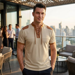 MannerCo apricot waffle knit pullover with lace-up stand collar and tan color-block detail, worn by man on rooftop