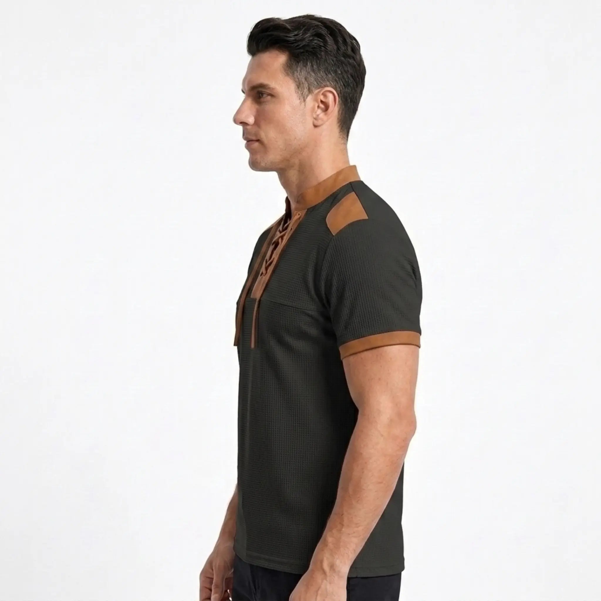 MannerCo black waffle knit pullover with tan stand collar, shoulder patch, and sleeve trim, side view