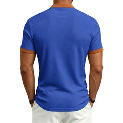MannerCo blue waffle knit color-block polo back view with tan collar and sleeve trim