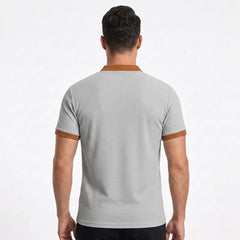 MannerCo light gray waffle knit polo back view with tan collar and sleeve trim