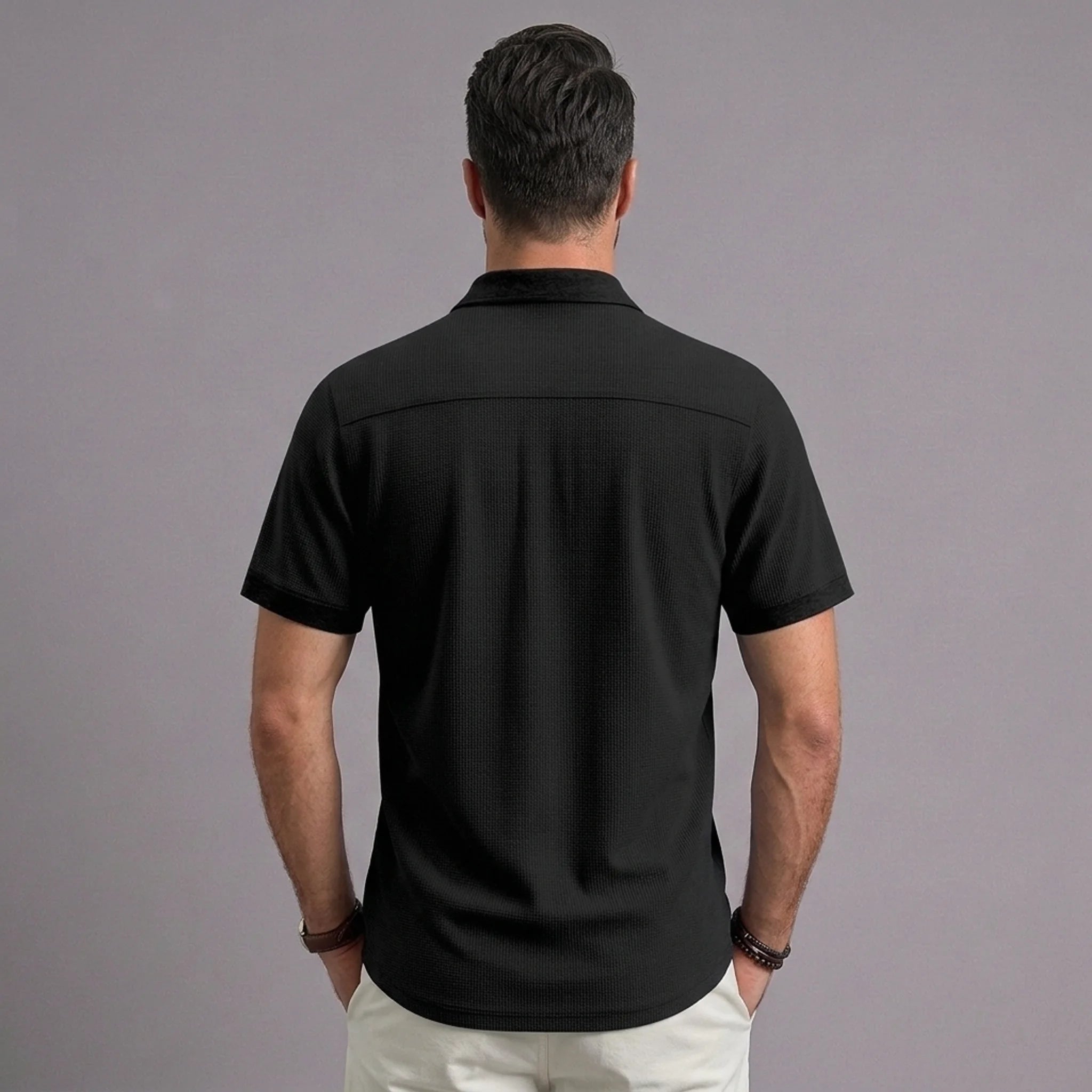 Back view of MannerCo black waffle knit short sleeve casual shirt with lapel collar