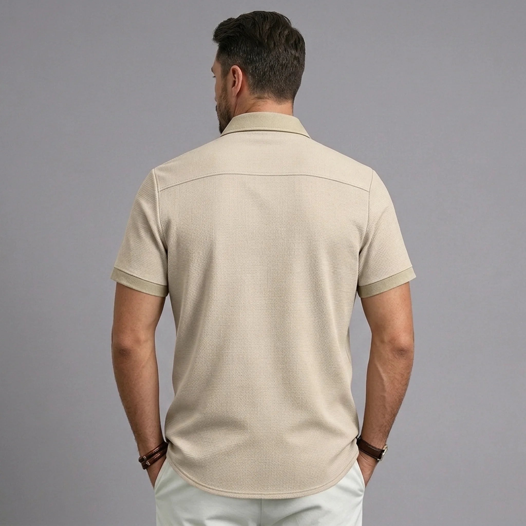 Back view of MannerCo khaki waffle knit short sleeve shirt with lapel collar and contrast cuffs
