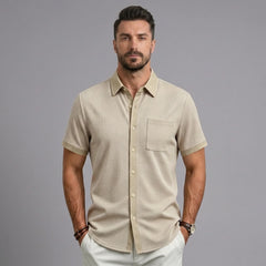 Man wearing khaki waffle knit short sleeve shirt with lapel collar and chest pocket