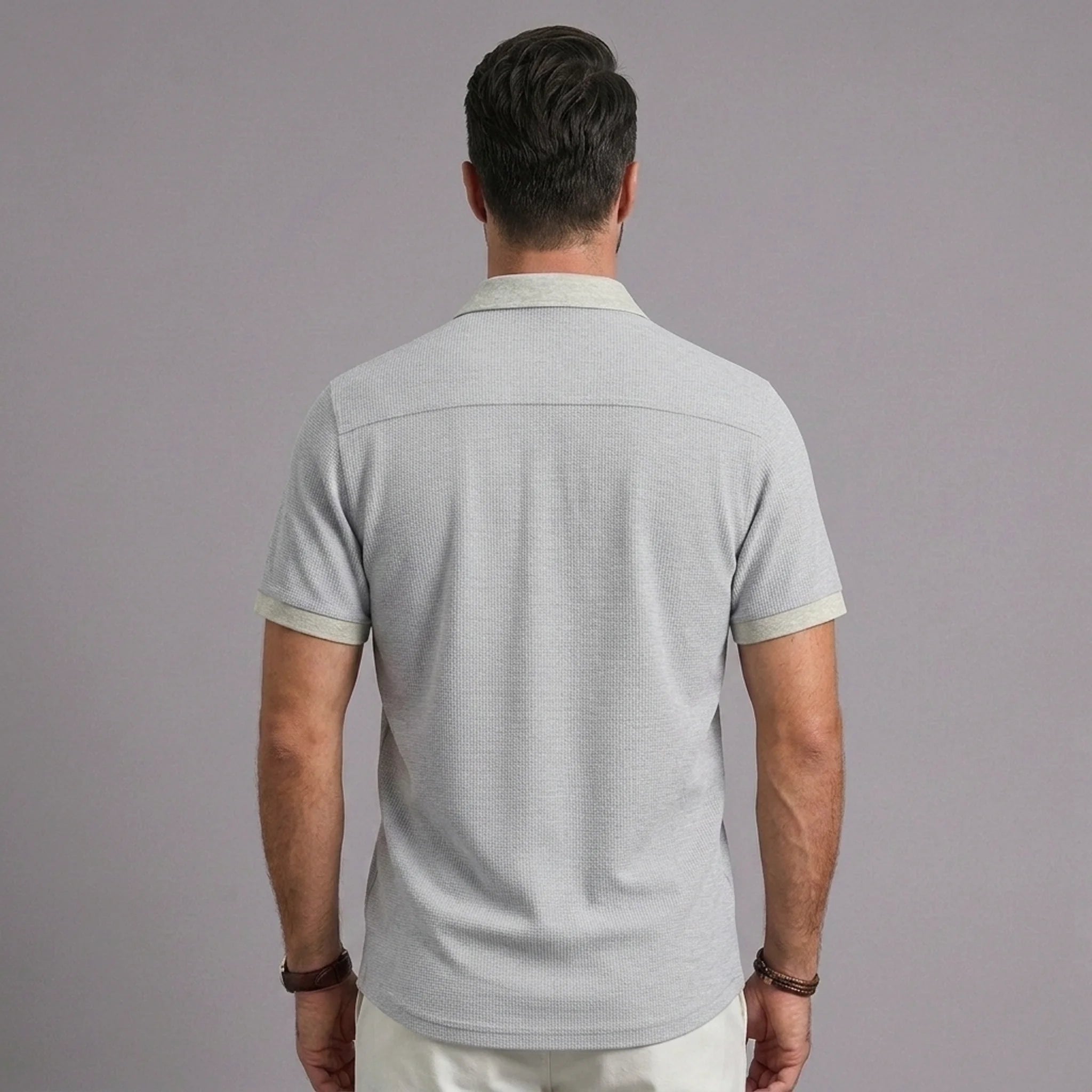 Back view of men's light gray waffle knit polo shirt with contrast collar and sleeve trim