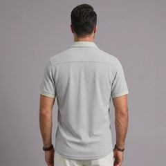 Back view of men's light gray waffle knit polo shirt with contrast collar and sleeve trim