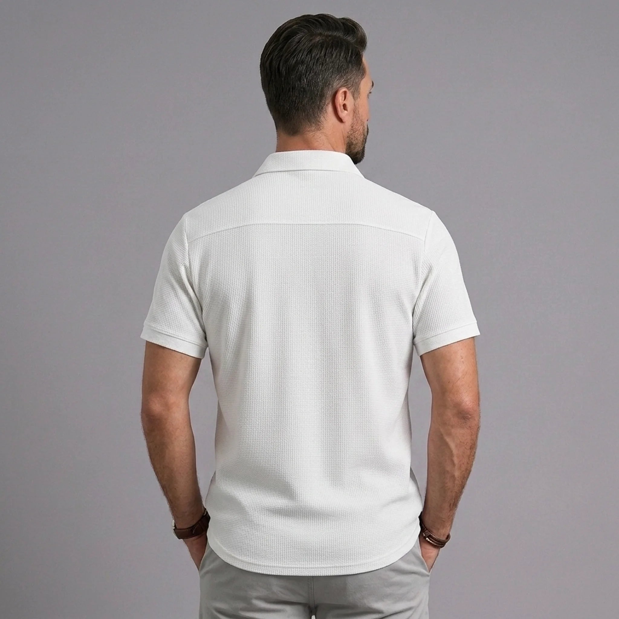 Back view of man wearing white waffle knit short sleeve casual shirt with lapel collar