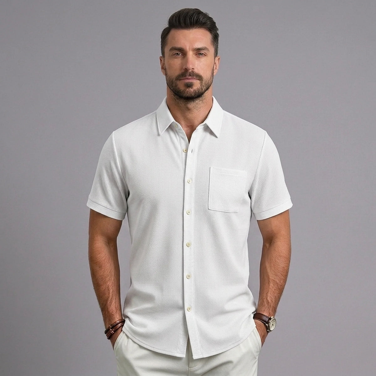 Man wearing MannerCo white waffle knit short sleeve shirt with lapel collar and chest pocket