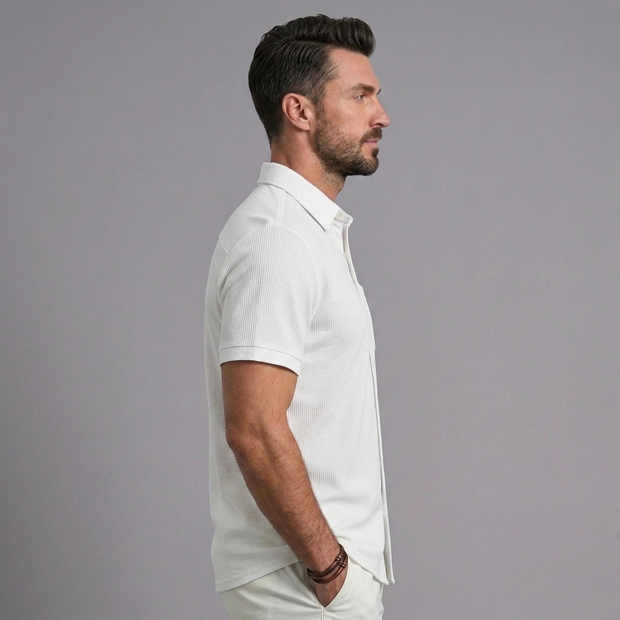 Man wearing white waffle knit short sleeve casual shirt with lapel collar, side profile view